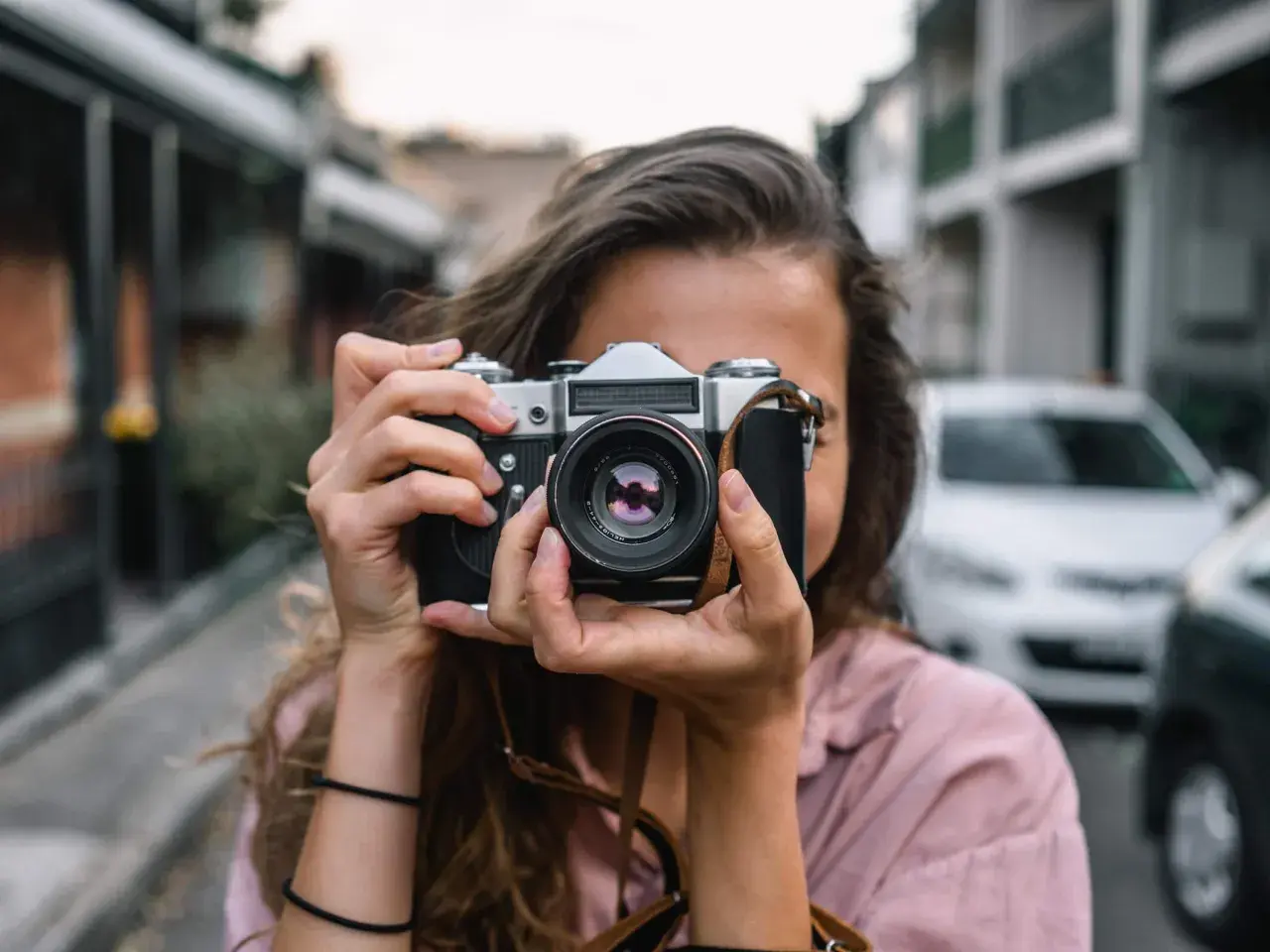 Dziewczyna z aparatem, idealna do kursu fotografii dla początkujących.