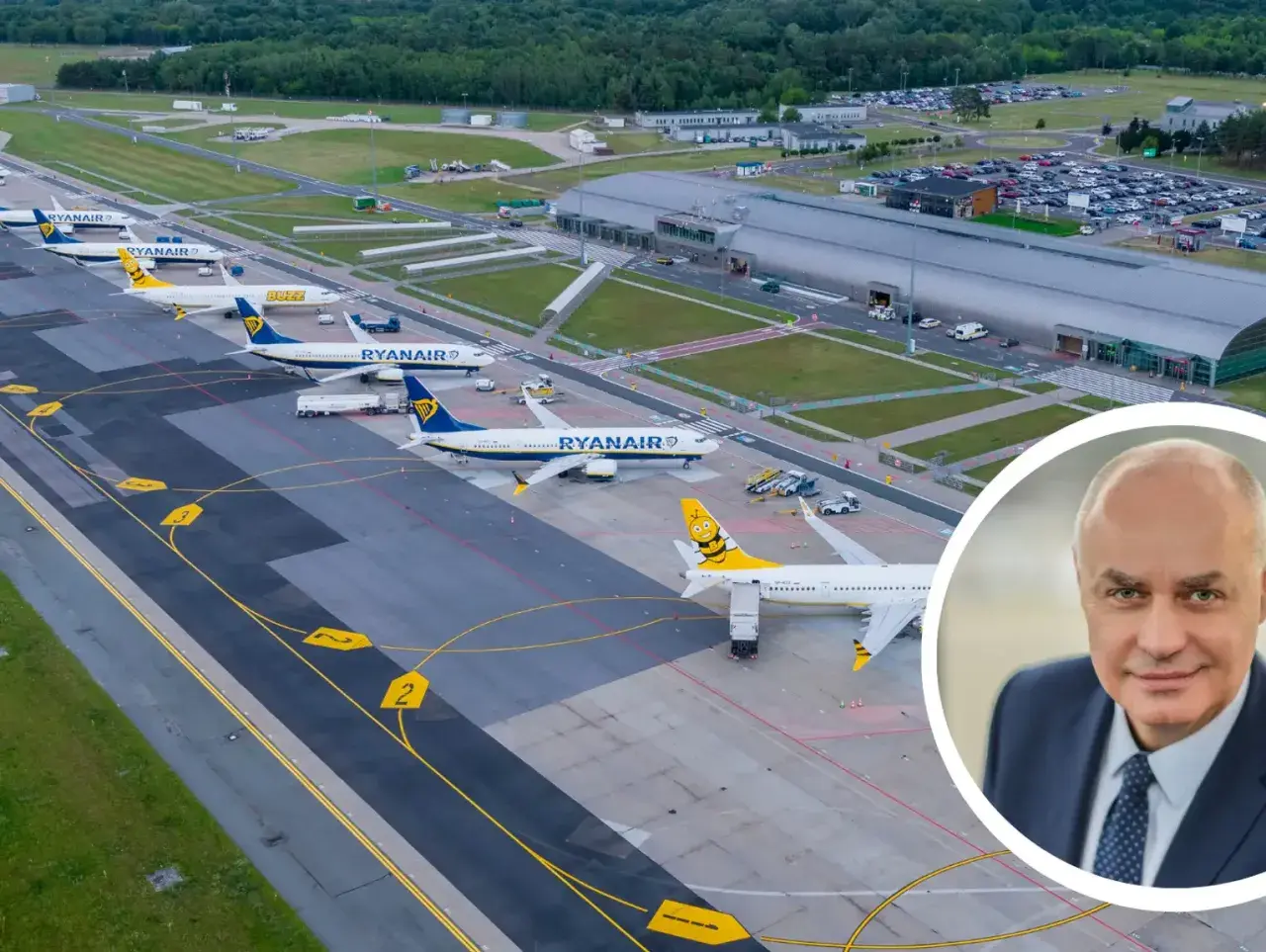 Samolot Ryanair na płycie lotniska. Czy lotnisko w Modlinie jest czynne? Tak, widać ruch samolotów i budynek terminala.