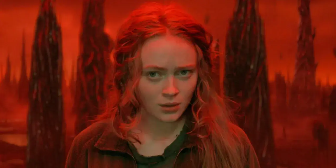 Max, le regard perdu dans le monde inversé de Stranger Things, entourée de formes sombres et menaçantes.