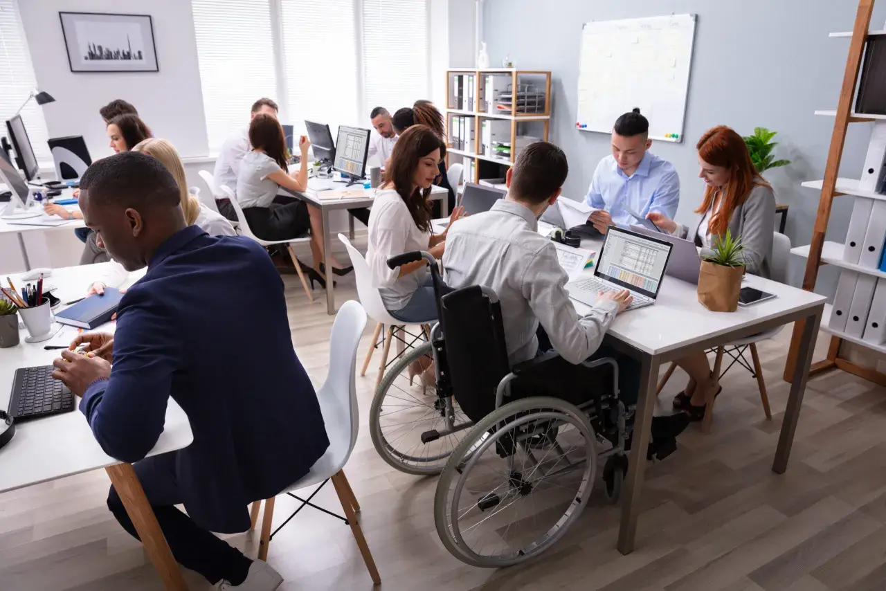 A diverse team collaborates in a modern office, showcasing the evolution of diversity and inclusion in the workplace.