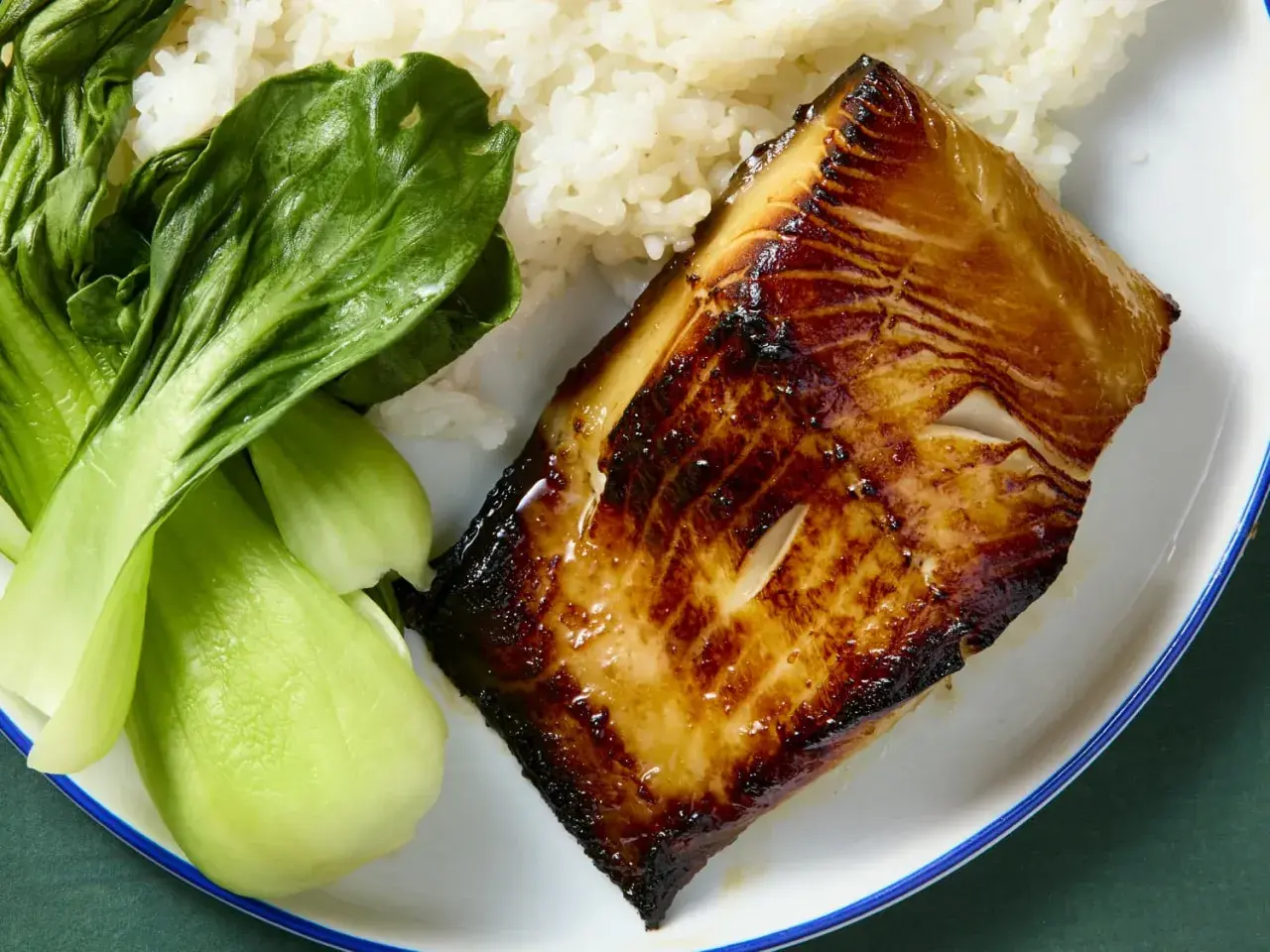 A perfectly seared miso cod recipe served with fluffy white rice and vibrant green bok choy.