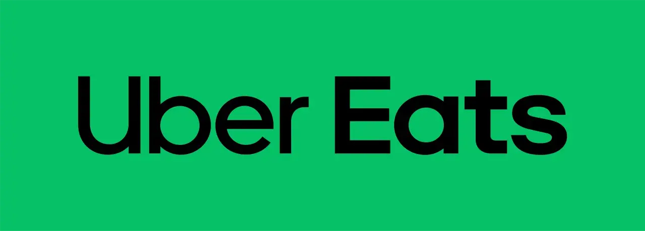Zielony ekran z czarnym napisem "Uber Eats". Idealny na voucher Uber Eats dla miłośników jedzenia.