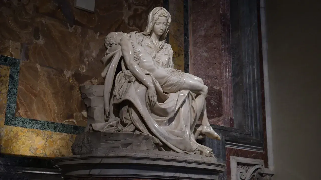 Pieta Michała Anioła: Matka Boska tuli martwe ciało Jezusa. Marmurowa rzeźba pełna bólu i piękna.