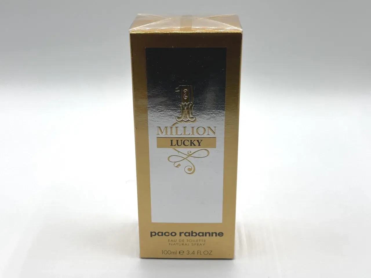 Złote opakowanie Paco Rabanne 1 Million Lucky 100ml z napisem "MILLION LUCKY" i ozdobnymi elementami.