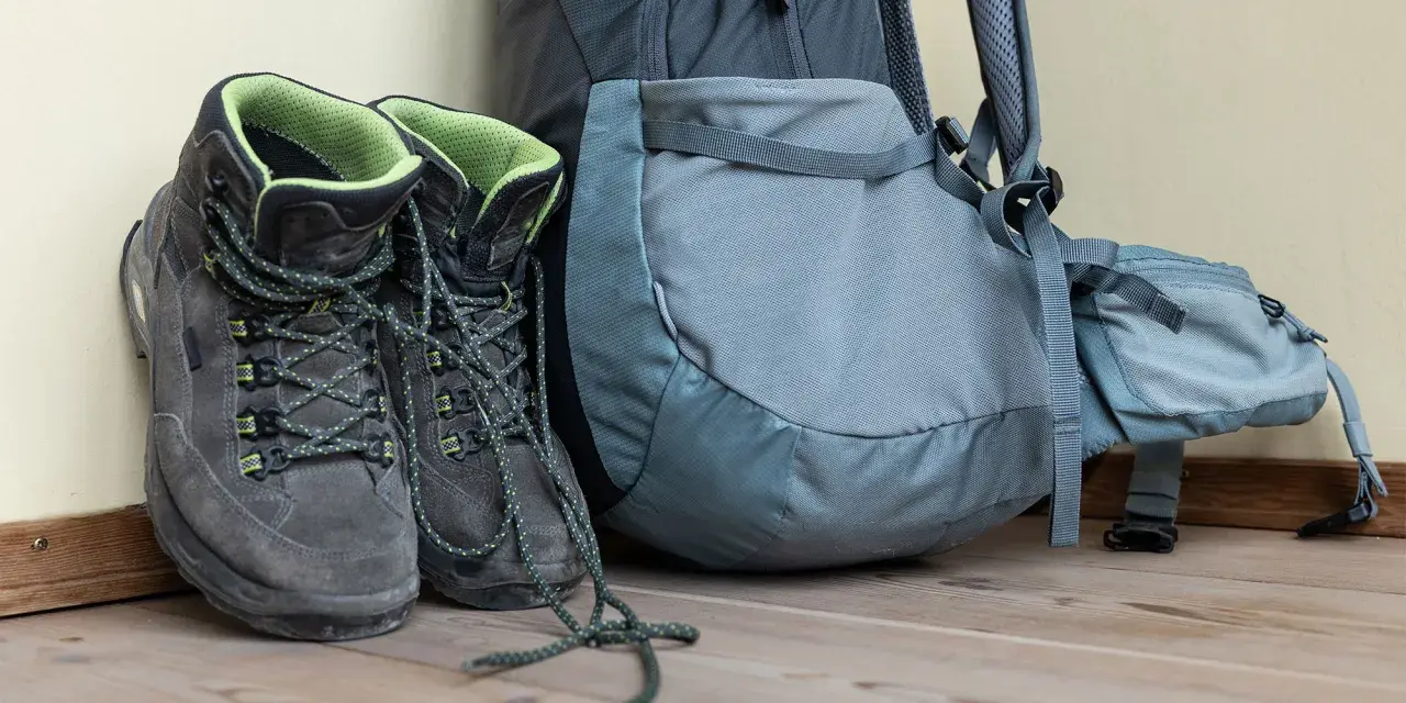 Hiking boots and backpack ready for adventure. Learn the best way to clean hiking boots to keep them in top condition for your next trek.