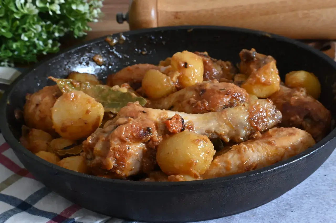 Un saporito pollo in umido con patate e alloro, cotto in padella.