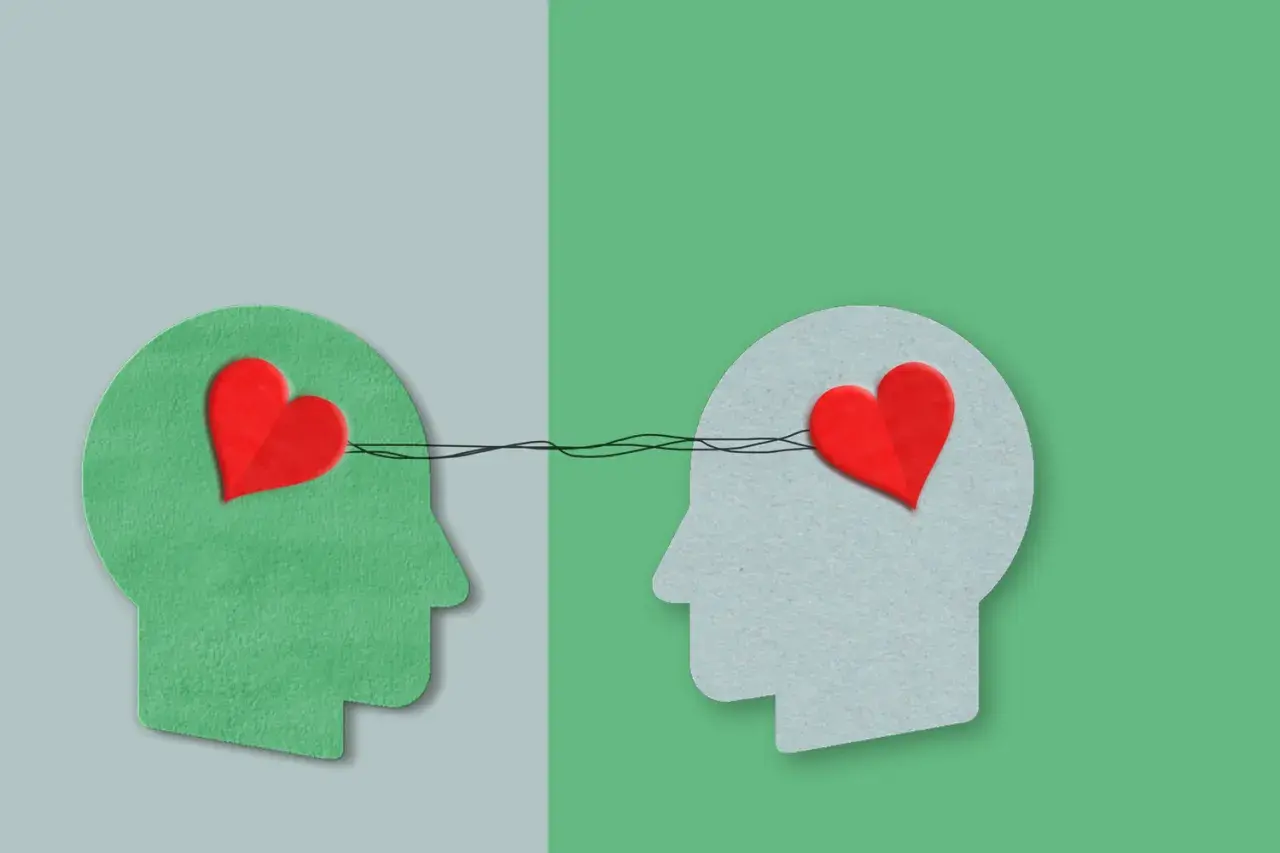 Twee profielen met harten verbonden door lijnen, symboliseren autisme en empathie.