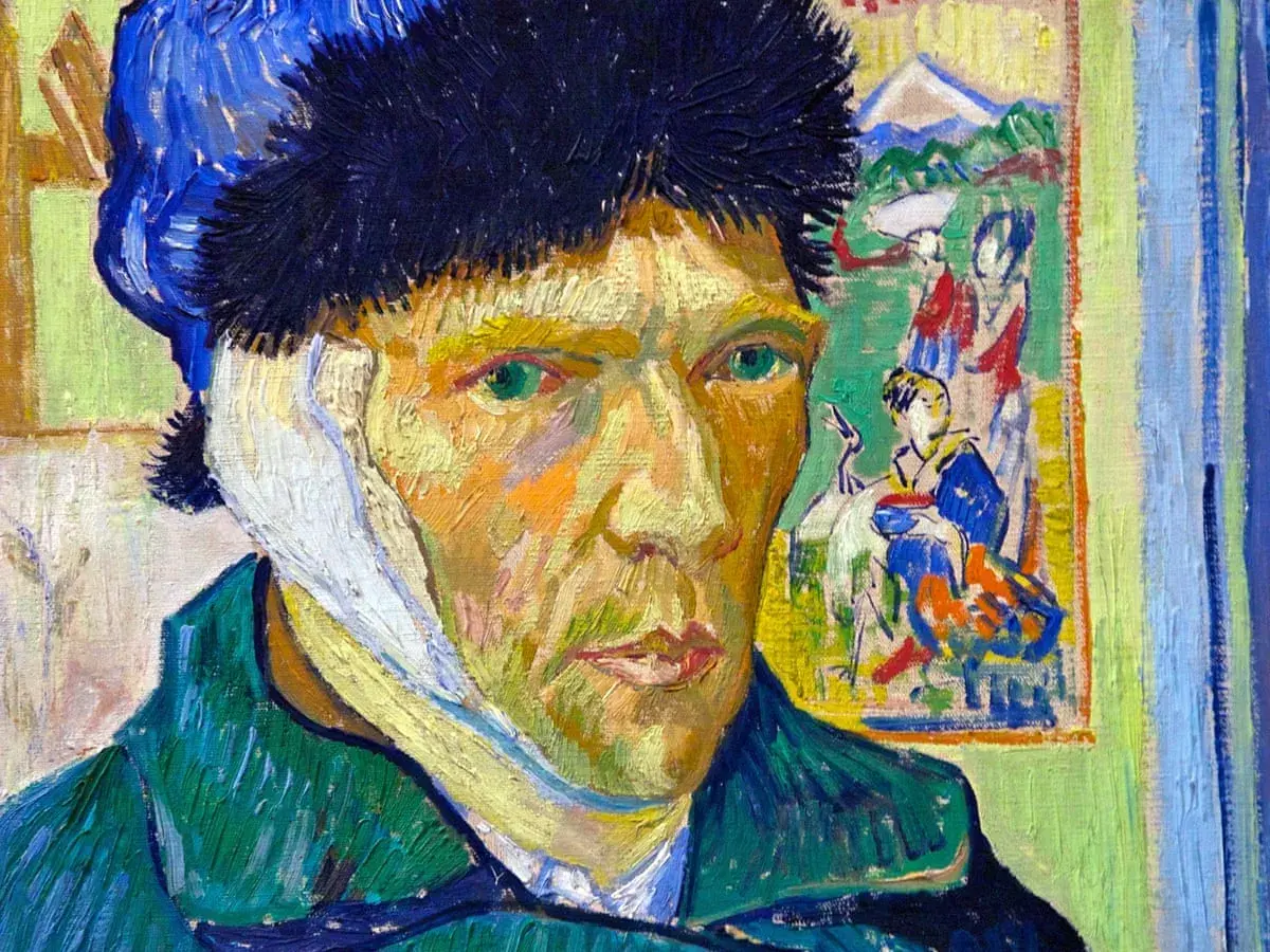 Van Gogh's self portrait with bandaged ear, his intense green eyes gaze out from a face painted with bold strokes.