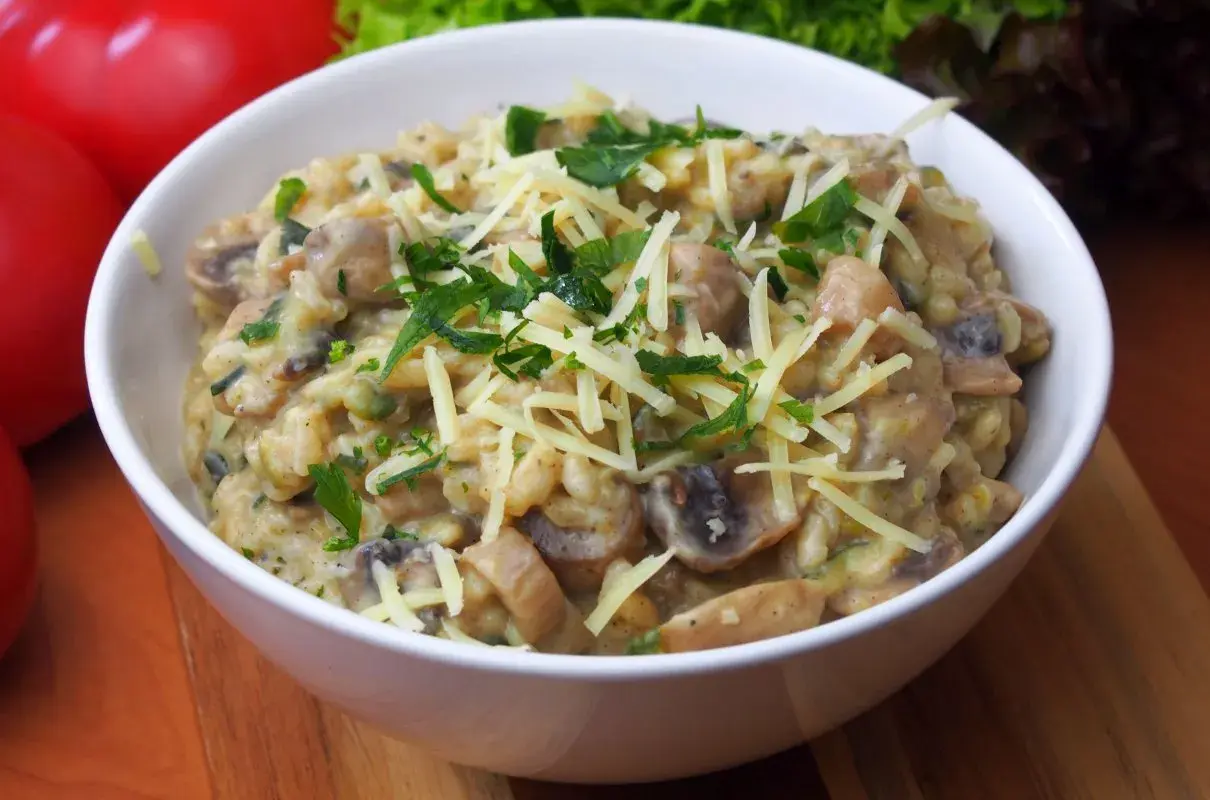 Aksamitne risotto z pieczarkami, posypane startym serem i świeżą natką pietruszki. Idealne na jesienny obiad.