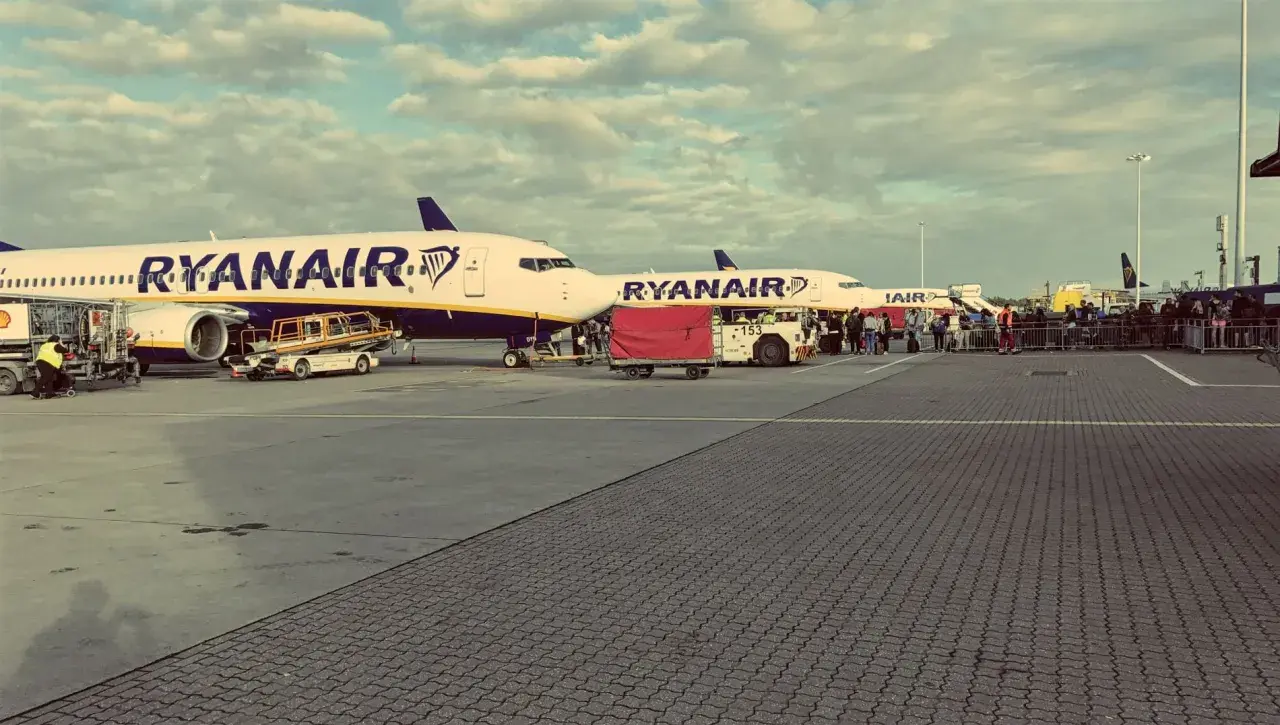 Ryanair-Flugzeuge am London Stansted Airport, bereit für den Flug nach London City. Passagiere warten in der Schlange.