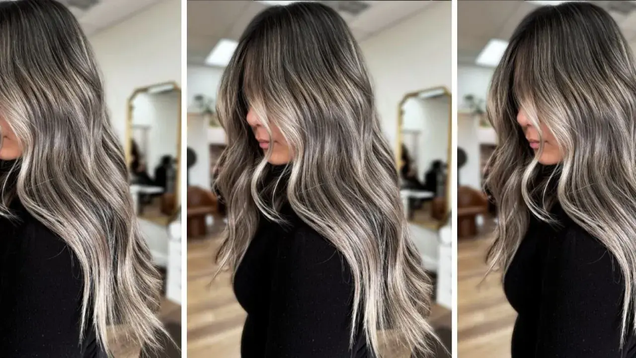 Pelo largo y ondulado con un degradado de color que combina canas y mechas rubias, creando un efecto moderno y natural.