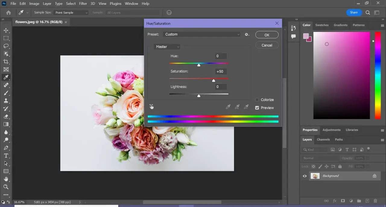 Un bouquet di fiori in fase di photoshop color correction, con la finestra Hue/Saturation aperta per regolare la saturazione.