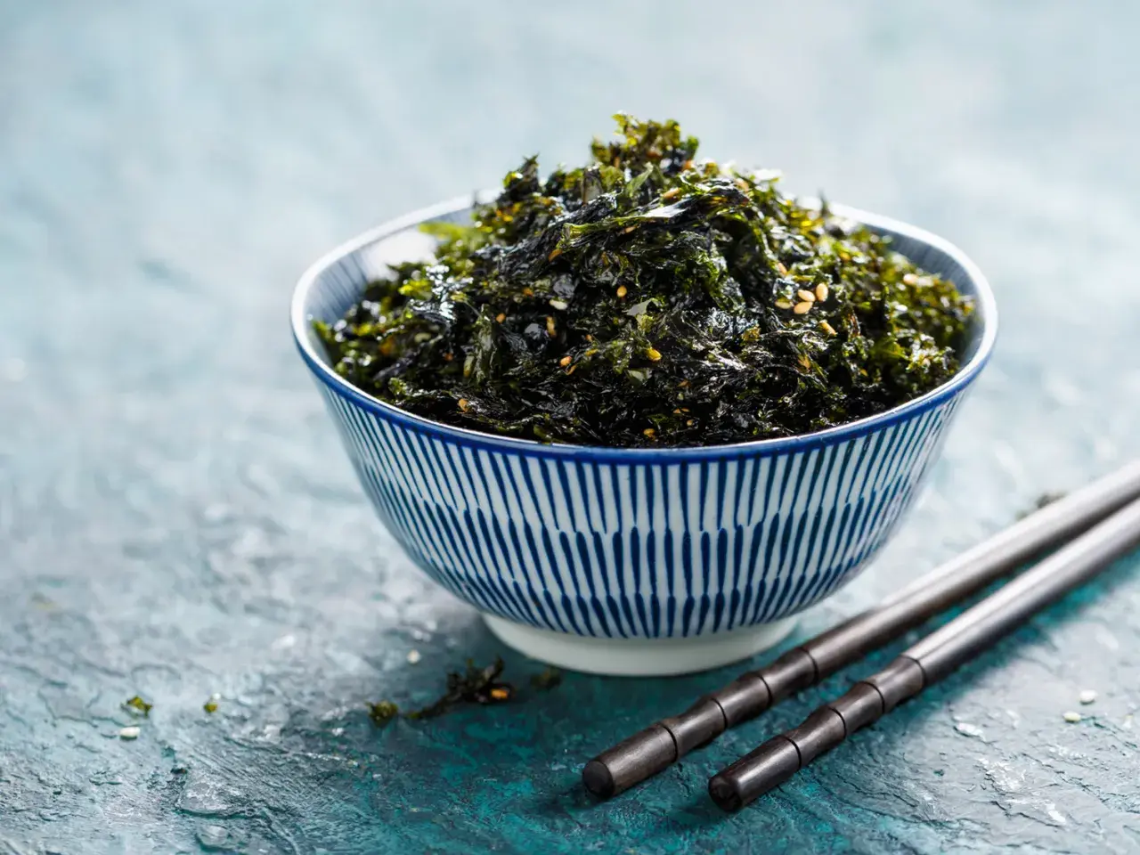 Ciotola di alga nori croccante, condita con semi di sesamo. Perfetta per accompagnare riso o come snack. Ecco alga nori come usarla!