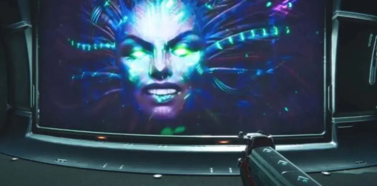 Złowroga twarz SHODAN na ekranie, otoczona neonowymi kablami, zapowiada kolejne wyzwania w System Shock 3.