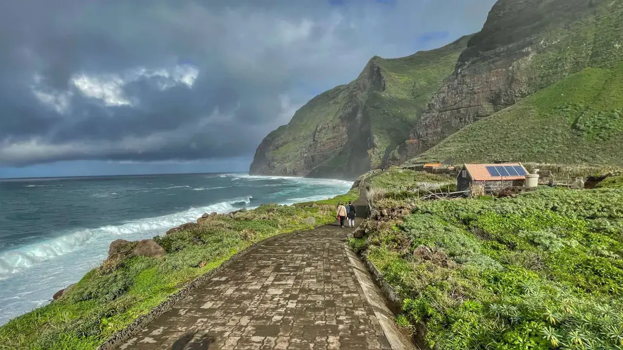 A scenic walk along the coast of Madeira, with dramatic cliffs and crashing waves. This view captures the essence of a week in Madeira.