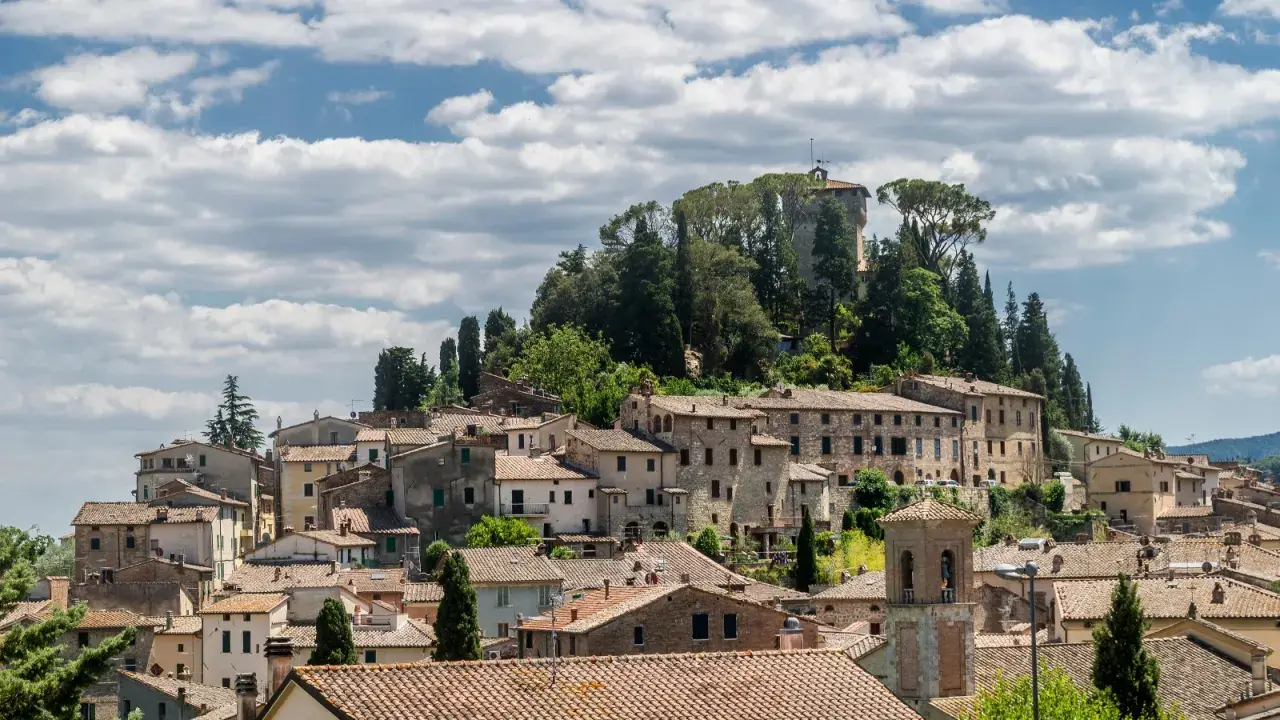 Panoramica di Cetona, un borgo toscano con case in pietra e tetti in cotto, dominato da una torre antica. Cosa vedere in questo incantevole paesaggio.