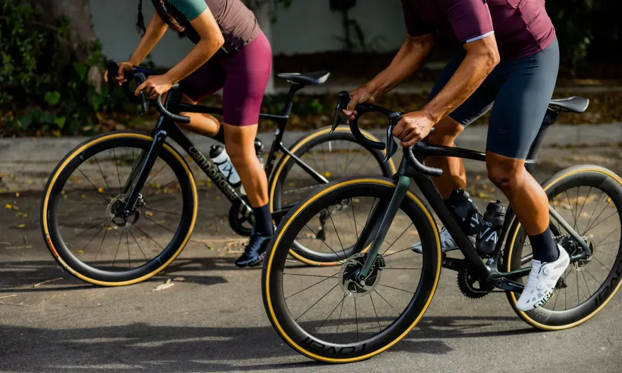 Two cyclists on road bikes, one with a blue book in their jersey pocket, showcase the value of a high-performance bike.