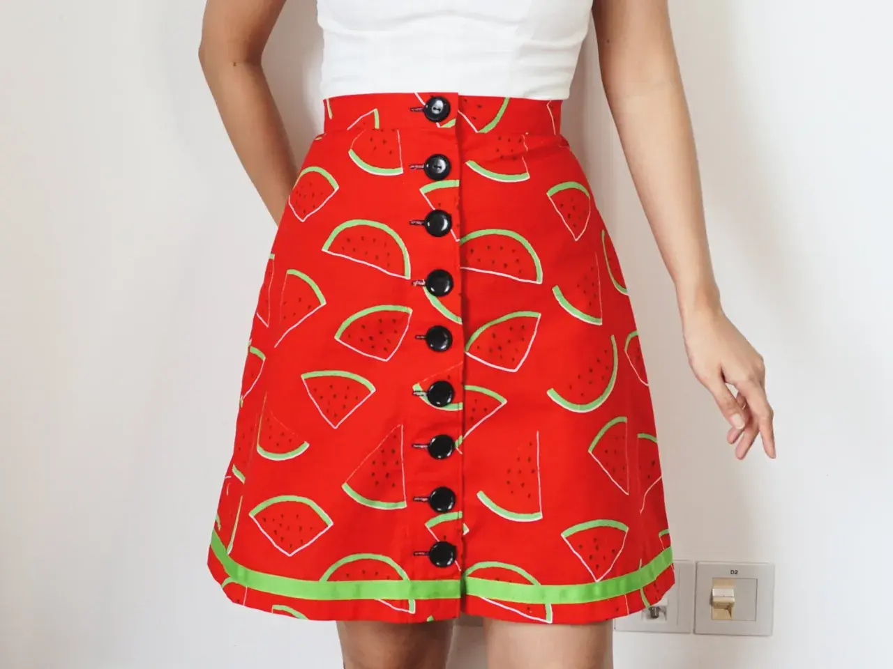 A-line skirt with a fun watermelon print, featuring black buttons down the front. Get this printable a line skirt pattern free and sew your own summer style!