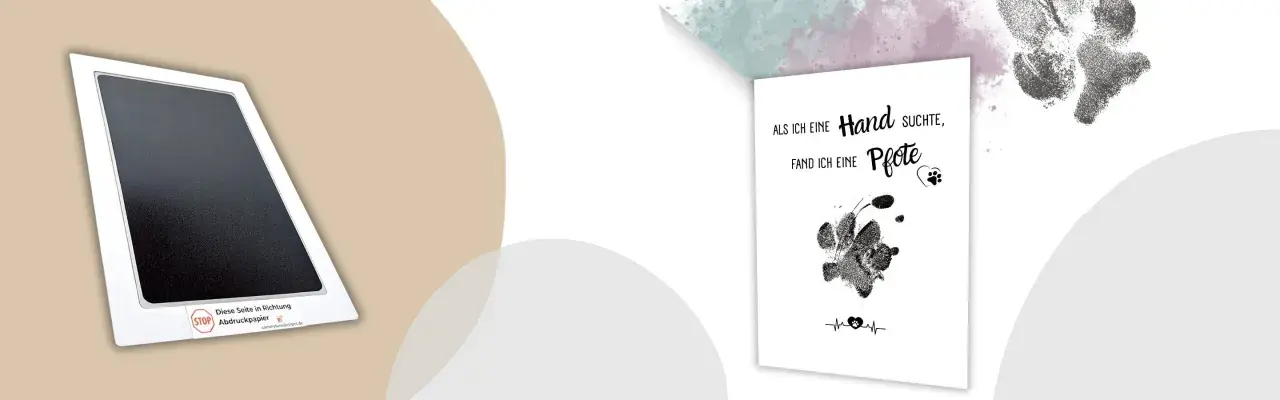 Pfotenabdruck Hund selber machen: Ein Abdruckpapier-Set und eine Karte mit Pfotenabdruck und Spruch.