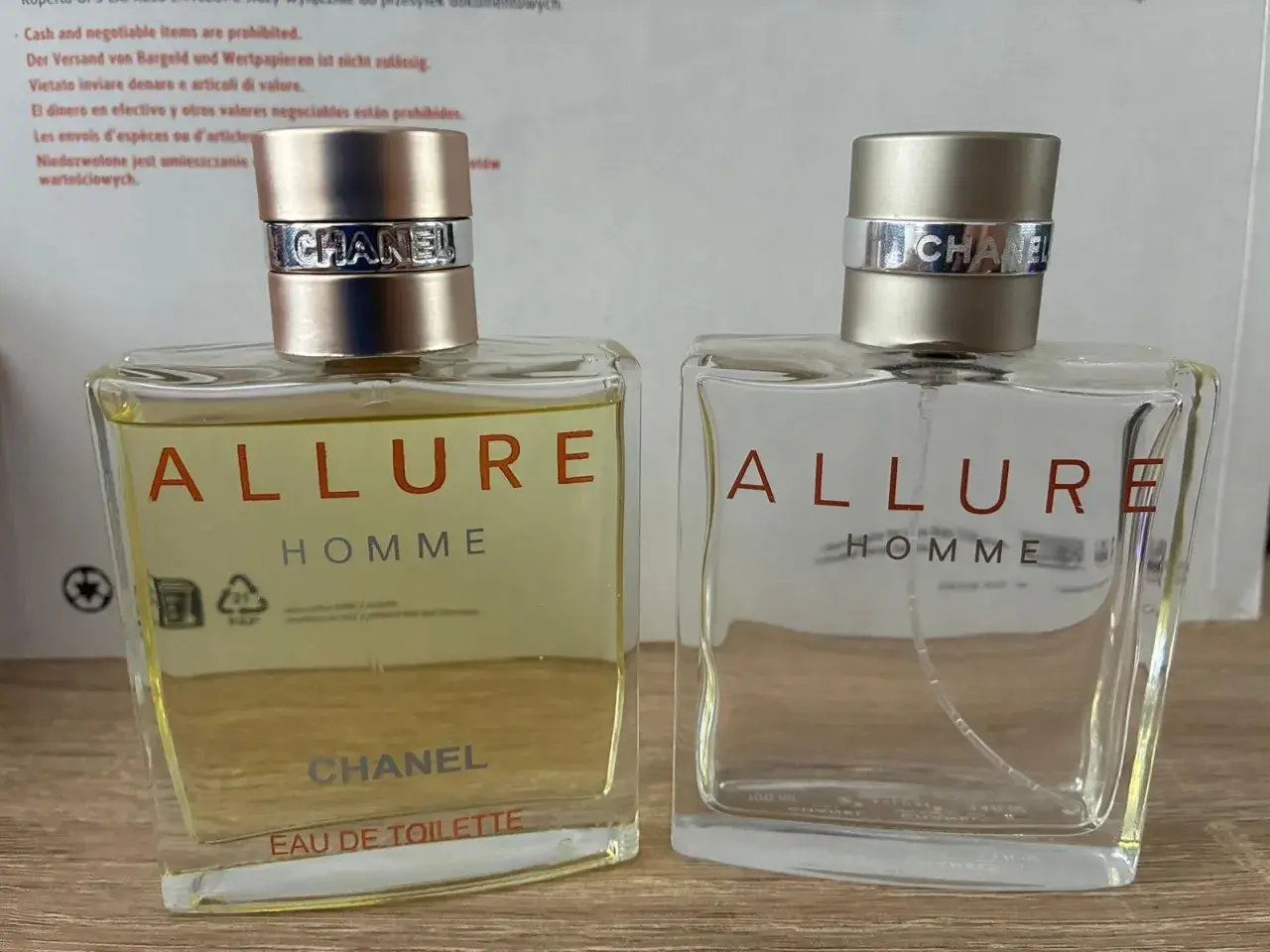 Dwa flakony perfum Chanel Allure Homme. Jeden pełny, drugi prawie pusty. Klasyczny zapach, który dodaje pewności siebie.