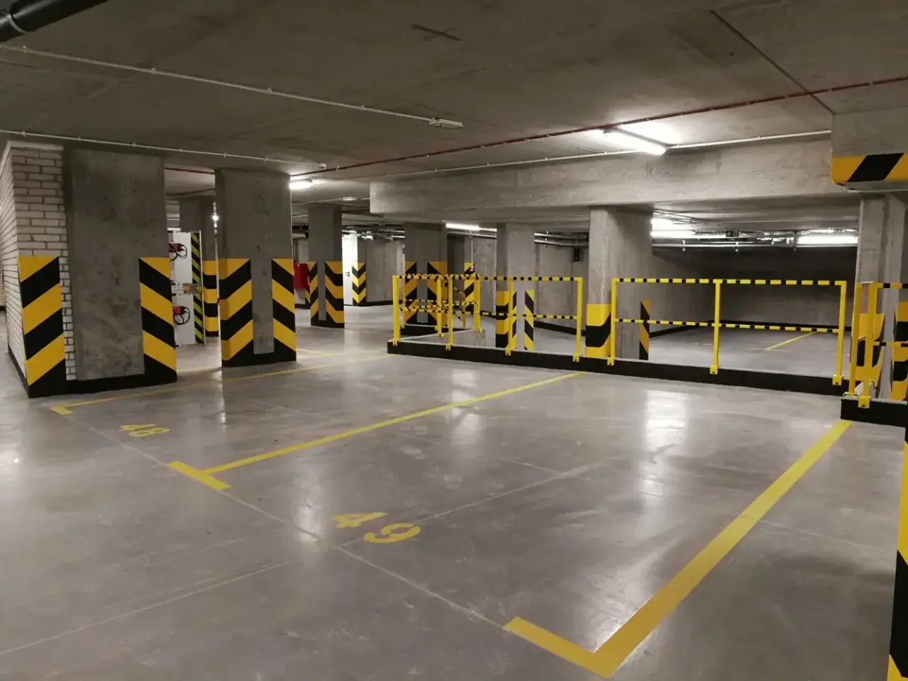 Nowe, puste miejsca parkingowe pod blokiem. Zastanawiasz się, ile kosztuje miejsce parkingowe pod blokiem?