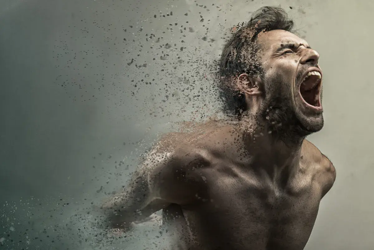 Uomo che urla, dissolvendosi in particelle, con un'espressione di profonda paura di impazzire.