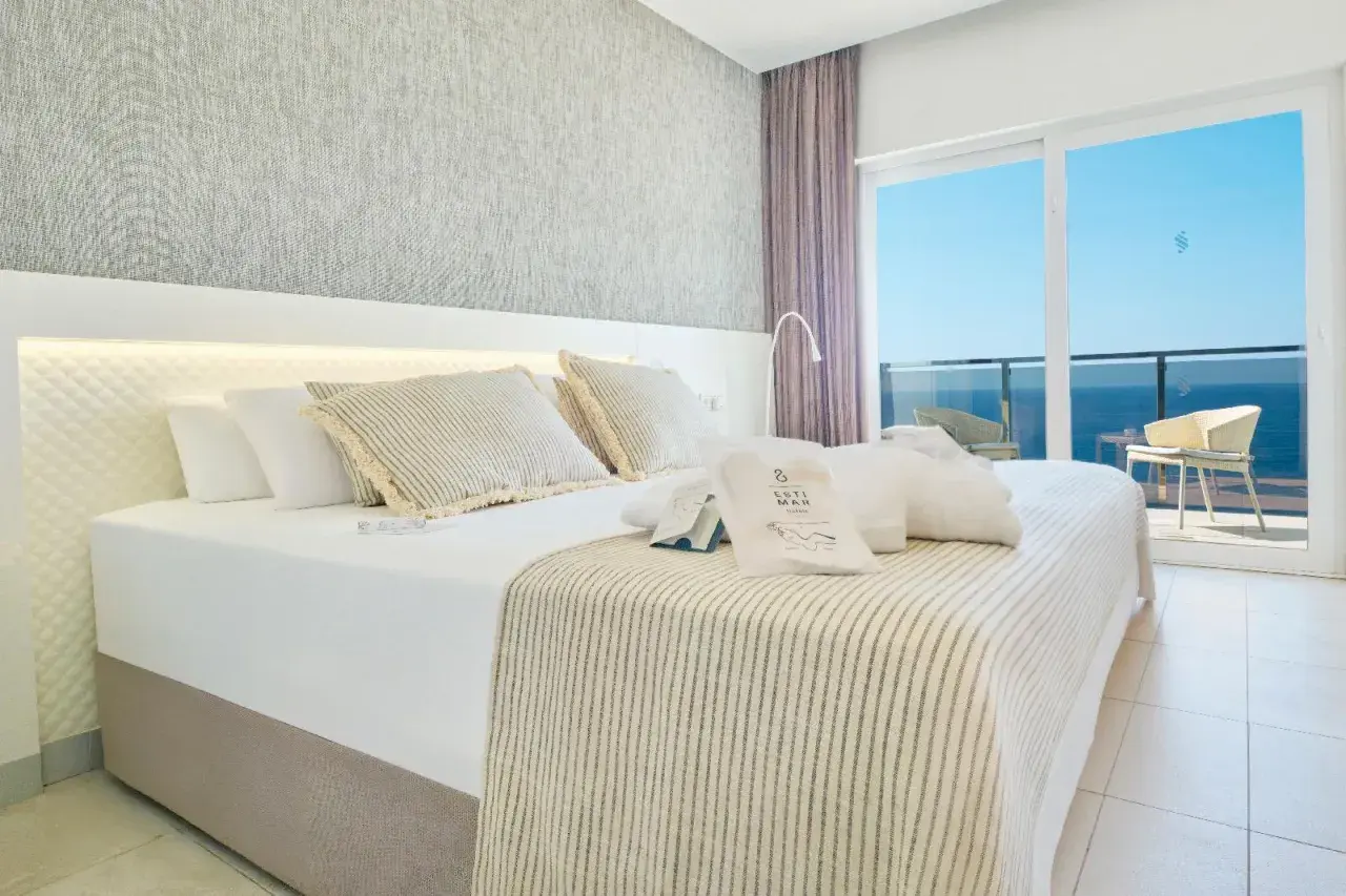Habitación con cama king, vistas al mar y amenities de Suitopia Spa Calpe.