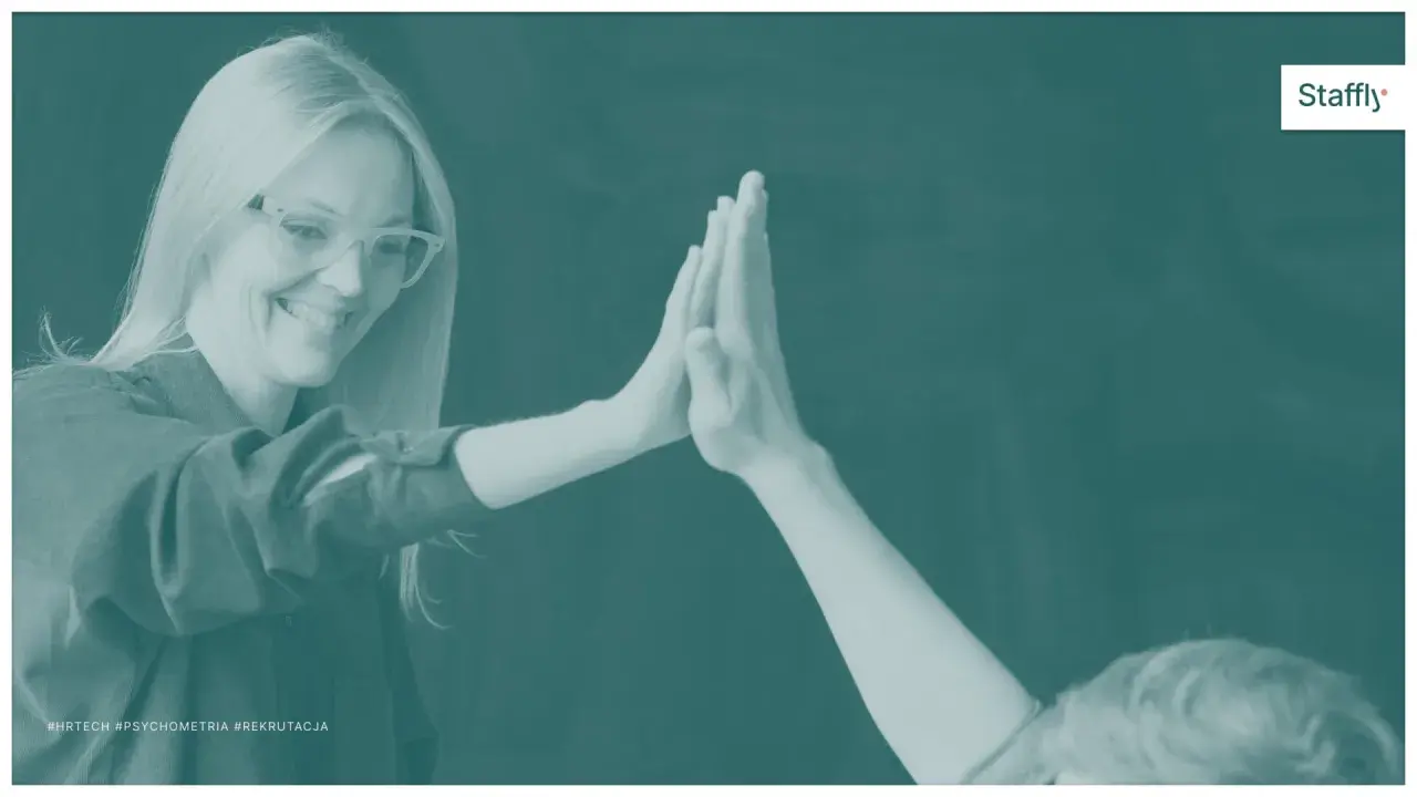Uśmiechnięta kobieta w okularach daje "piątkę". Czy to przejaw ekstrawersji? #HRTech #Psychometria #Rekrutacja