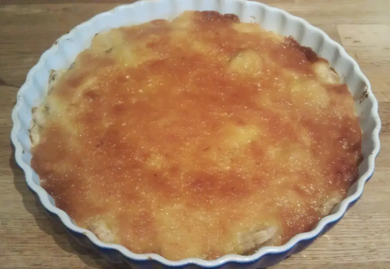 En gyllene bananpaj i en vit form, redo att avnjutas. Ett perfekt bananpaj recept för fikat.