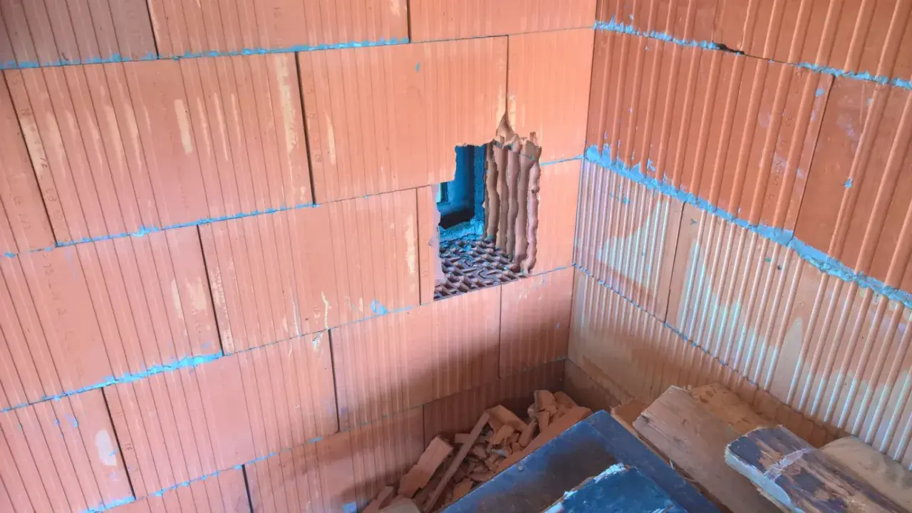 Otwór w ścianie z pustaków ceramicznych, przygotowany pod wentylację garażu przez ścianę.