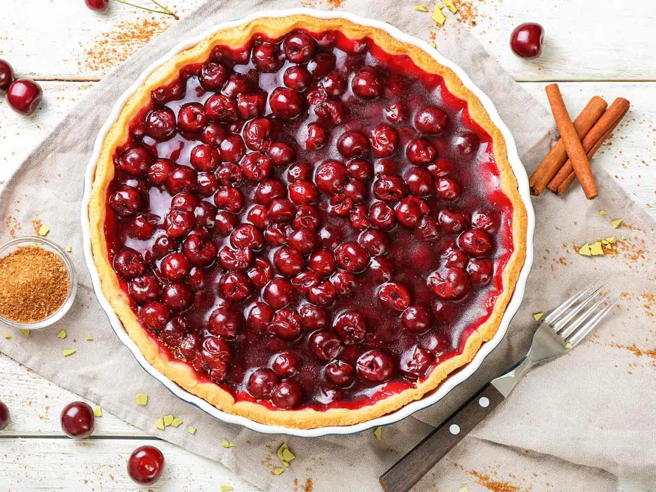 Une délicieuse tarte aux cerises, garnie de fruits rouges brillants et d'une croûte dorée. Parfaite pour un dessert gourmand.