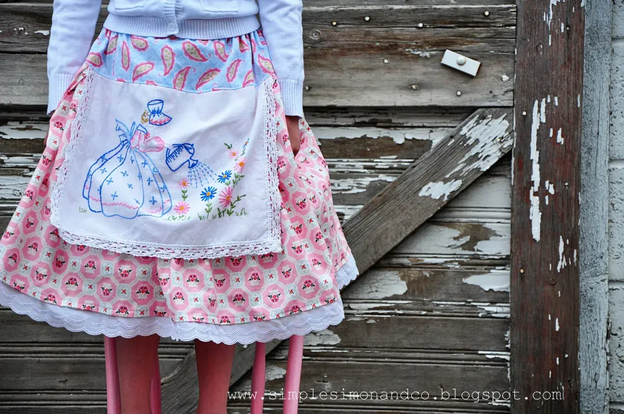 A vintage apron skirt pattern with a girl watering flowers, set against a rustic wooden background.