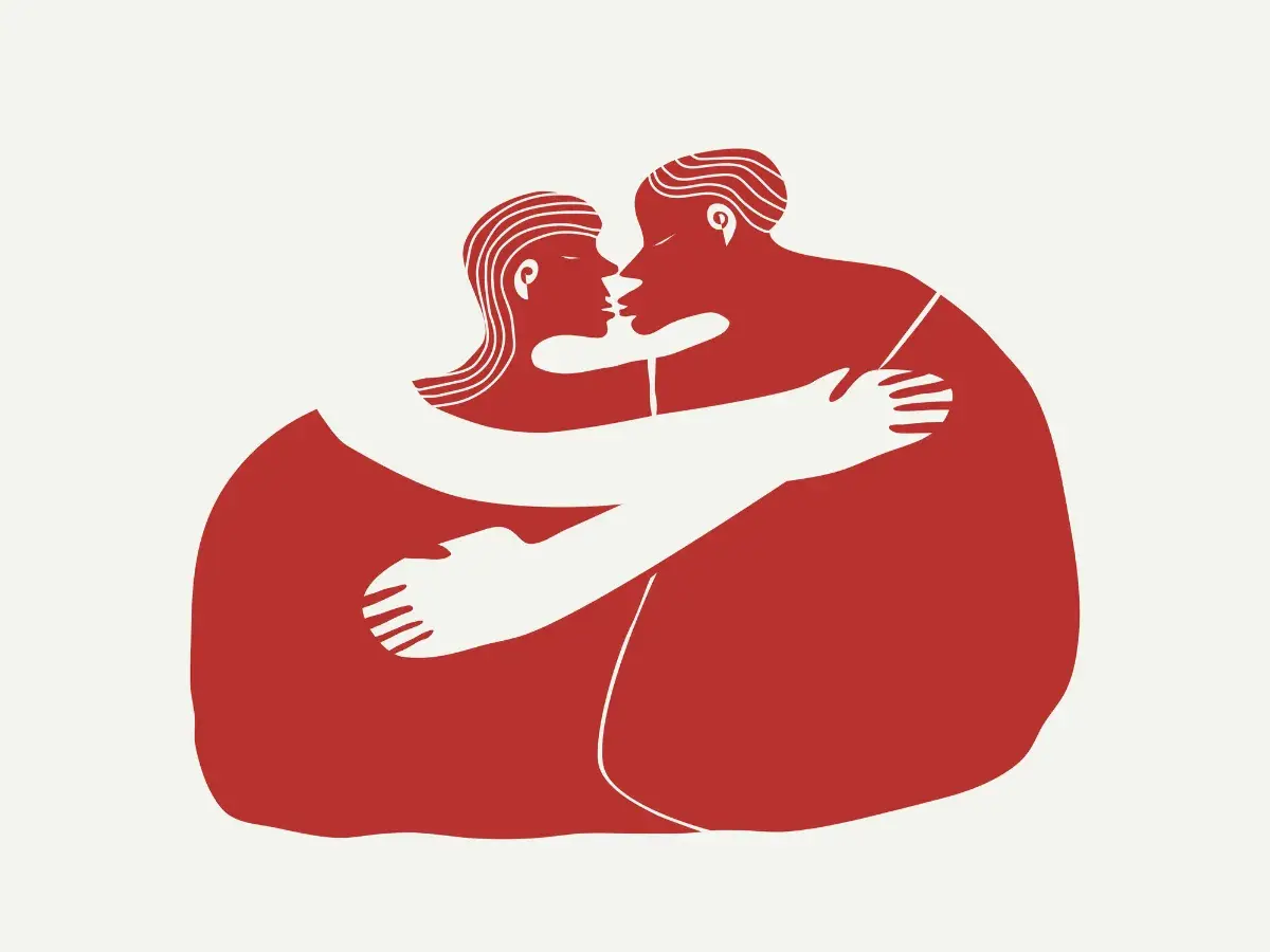 Dwie postacie w czerwieni obejmują się czule. Ilustracja podkreśla potrzebę przytulania u dorosłych, symbolizując bliskość i wsparcie.