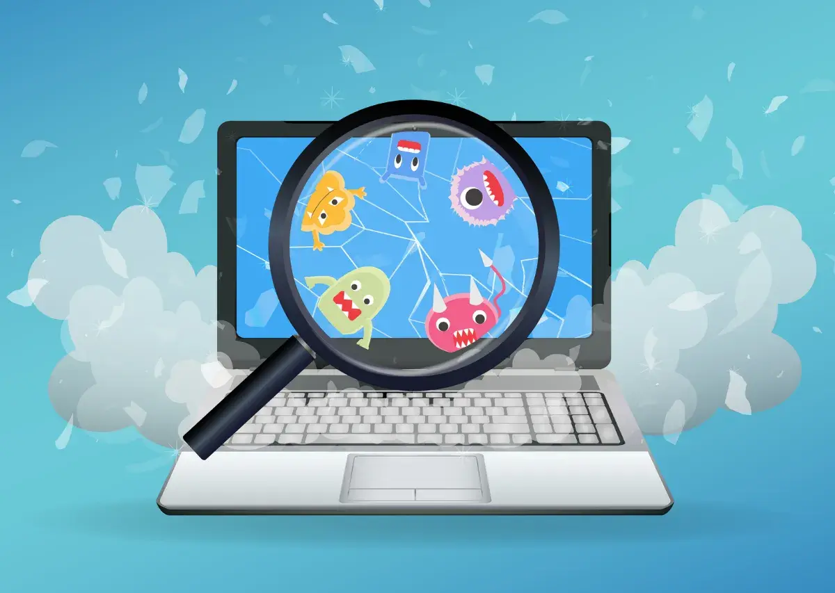 Laptop z kolorowymi potworkami na ekranie, powiększonymi przez lupę. Dowiedz się, jak usunąć wirusa z komputera i pozbyć się tych intruzów.