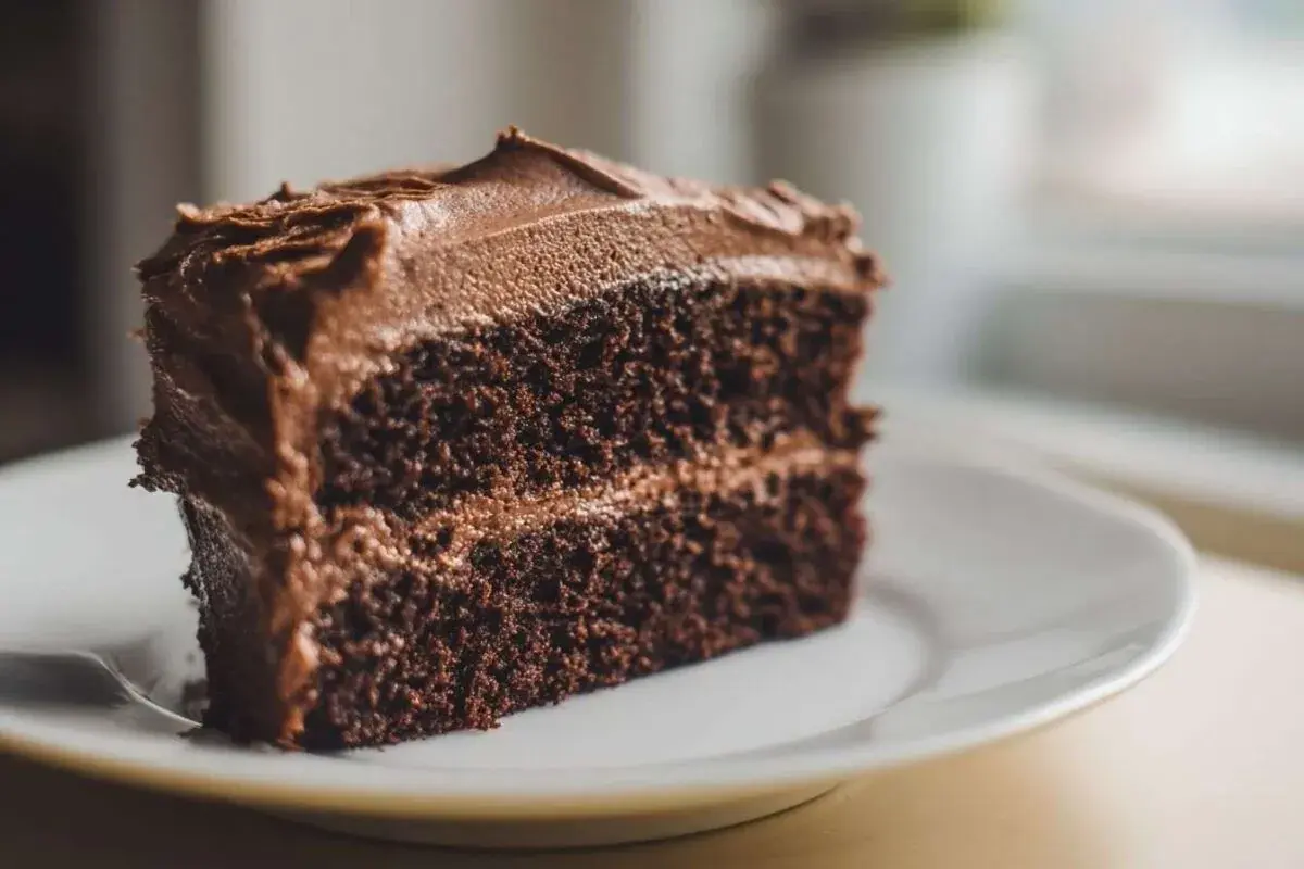 Une part généreuse de cake au chocolat, avec un glaçage onctueux et une texture moelleuse. Un délice pour les amateurs de chocolat.