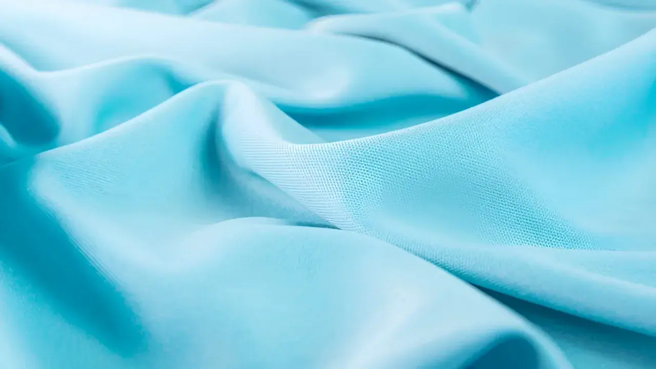 Soft, flowing turquoise lyocell fabric with subtle texture.