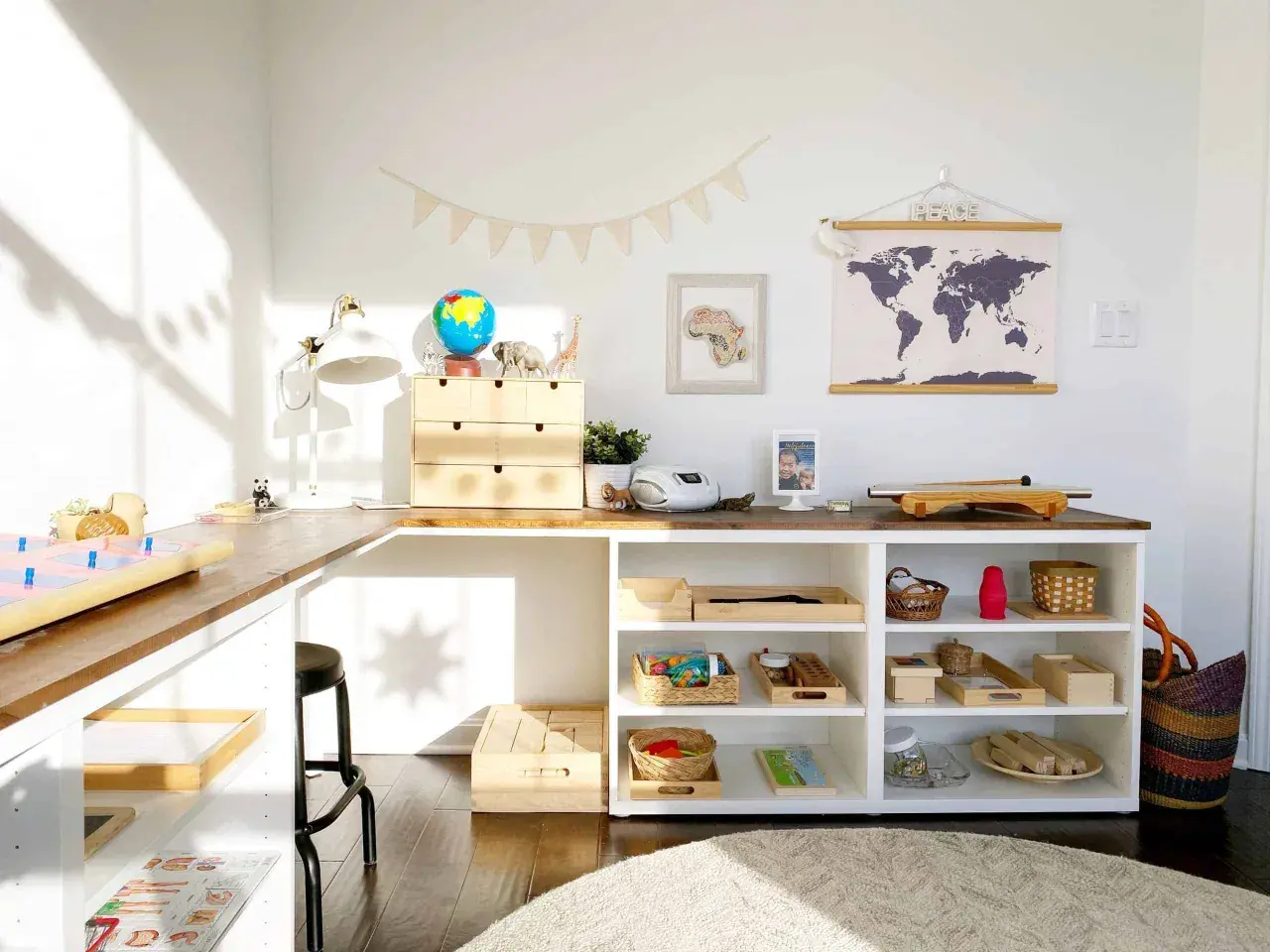 Inspiring Montessori shelf ideas for a child's learning space, featuring a globe, animal figures, and organized trays of educational materials.