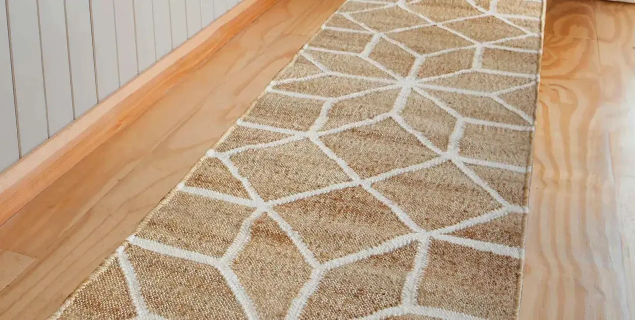 A natural fiber hallway runner with a geometric pattern. This image prompts the question: how long should a hallway runner be to perfectly fit your space?