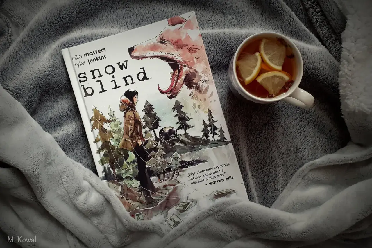 Okładka komiksu "Snow Blind" z wilkiem i postacią w lesie. Obok kubek z herbatą i cytryną. Idealny thriller na zimowe wieczory.