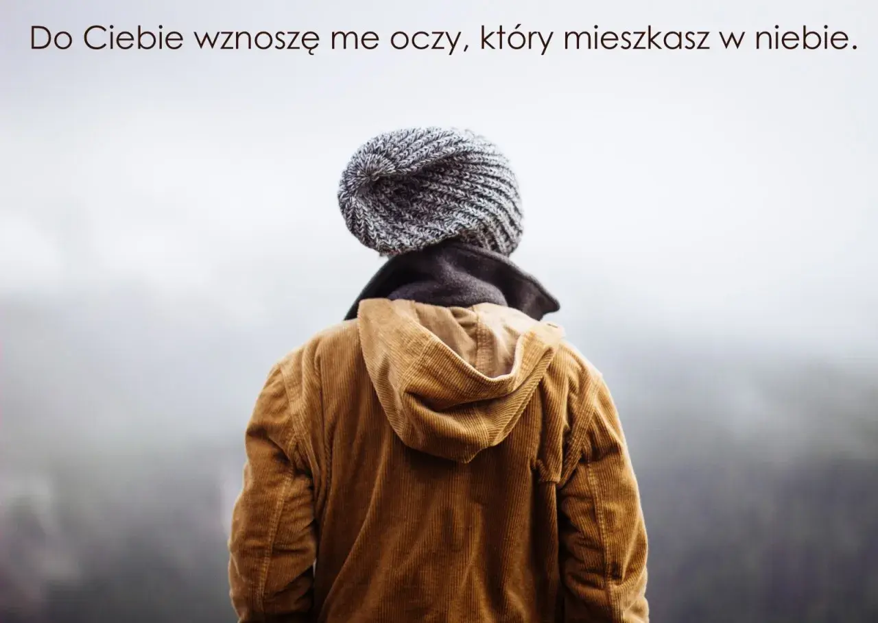Osoba w czapce i brązowej kurtce, patrząca w niebo. Cytat z Psalmu 134: "Do Ciebie wznoszę me oczy".