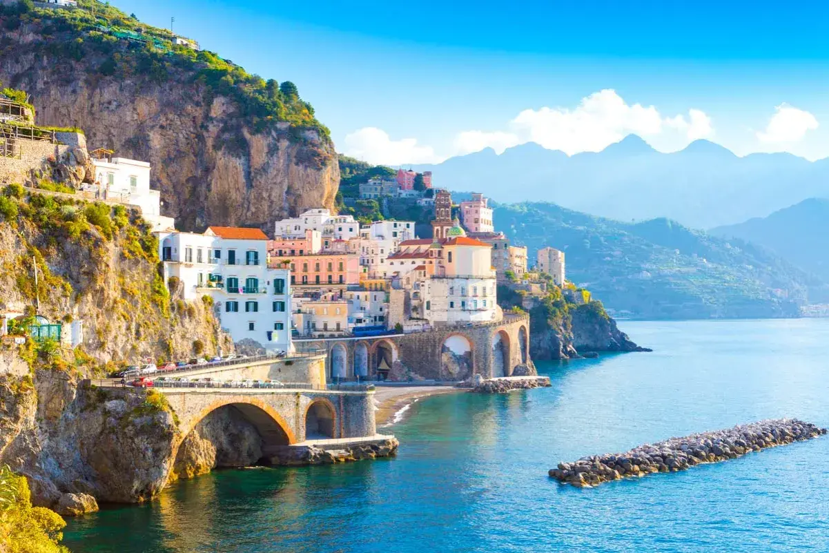 Colorful buildings cling to cliffs overlooking the sea. The Amalfi Coast is safe for exploring this picturesque Italian paradise.