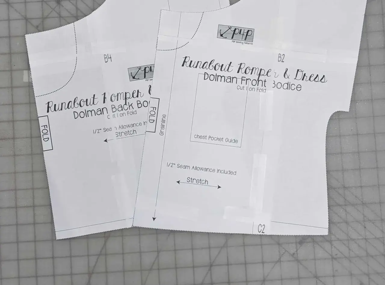 Close-up of a DIY romper pattern for a "Runabout Romper & Dress," showing front and back bodice pieces with instructions like "Cut 1 on Fold" and "Stretch.