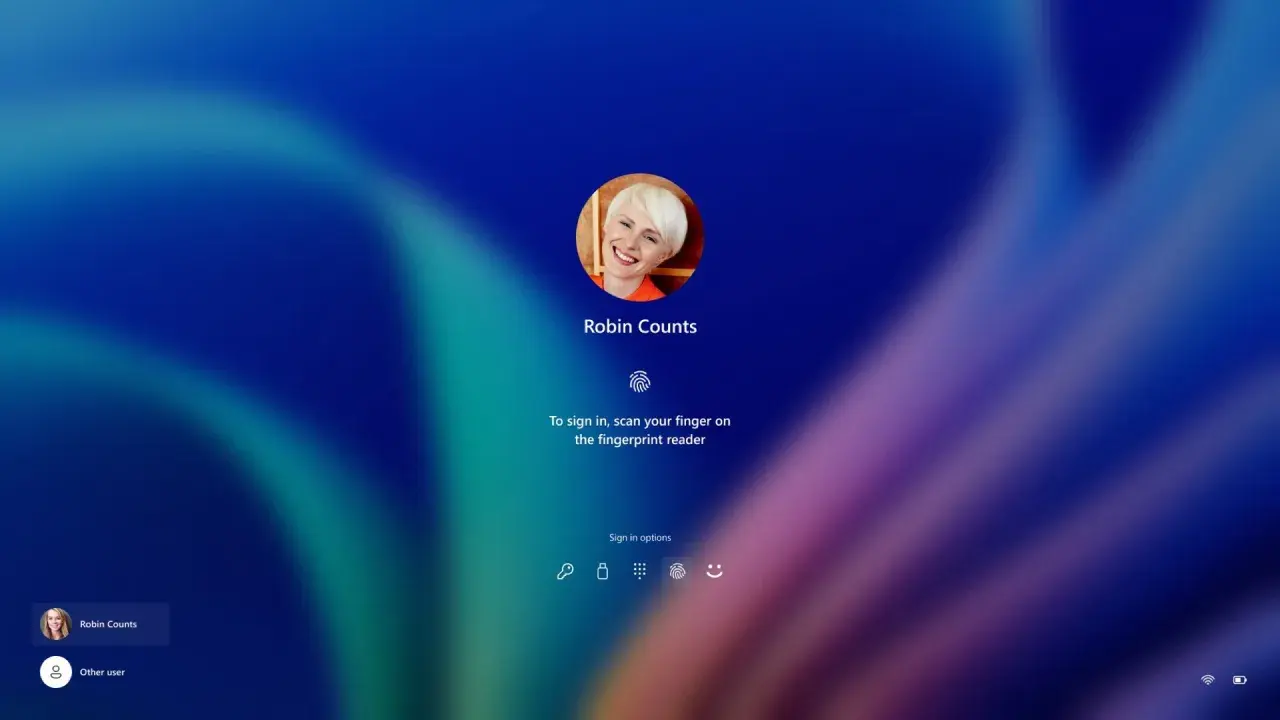 Ekran logowania Windows Hello z uśmiechniętą użytkowniczką Robin Counts, gotową do zeskanowania odcisku palca.