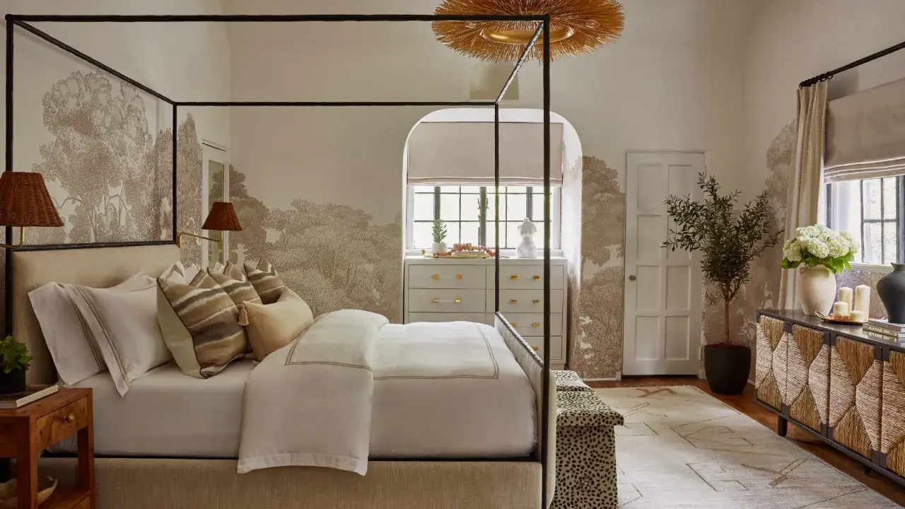 A serene bedroom featuring a canopy bed, botanical wallpaper, and a mix of natural textures, showcasing diverse bedroom styles.