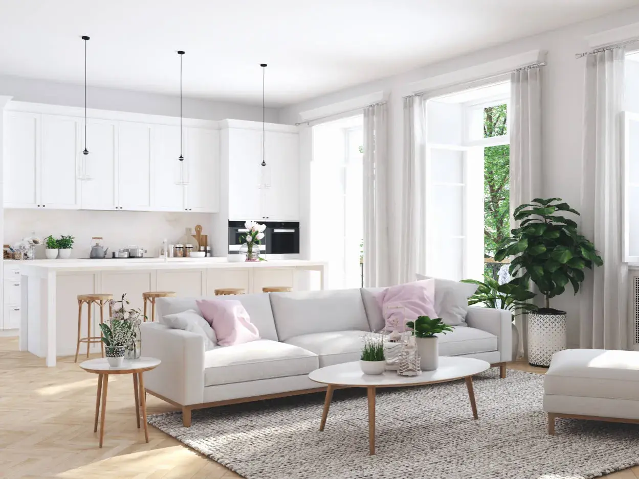 Illuminazione perfetta per un abbinamento lampadari open space: tre pendenti moderni sopra l'isola cucina e un'atmosfera accogliente nel soggiorno.
