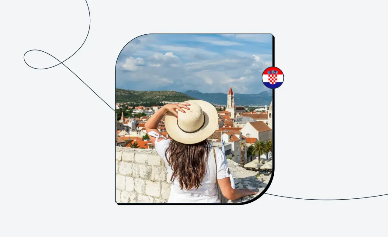 Kobieta w kapeluszu podziwia widok na chorwackie miasto. Chorwacja w strefie Schengen to marzenie wielu podróżników.