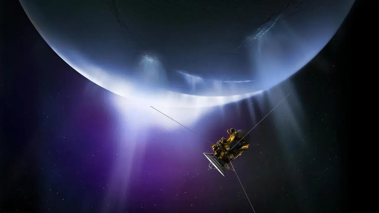 Sonda Cassini przelatuje obok lodowych gejzerów Enceladusa, księżyca Saturna, w kosmicznej purpurze.