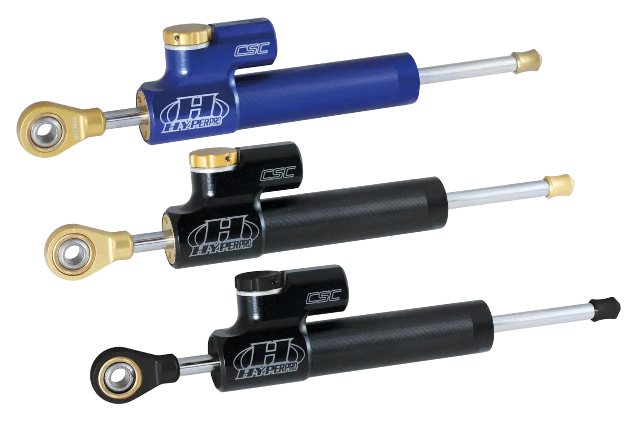 Tre ammortizzatori Hyperpro CSC, uno blu e due neri, perfetti per migliorare la stabilità delle Harley Davidson.