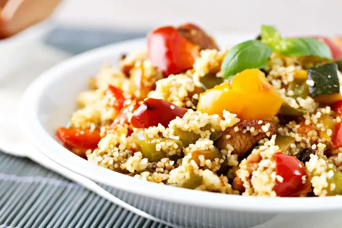 Cous cous con verdure colorate e basilico, un piatto leggero e gustoso, perfetto per le tue cous cous ricette sfiziose.