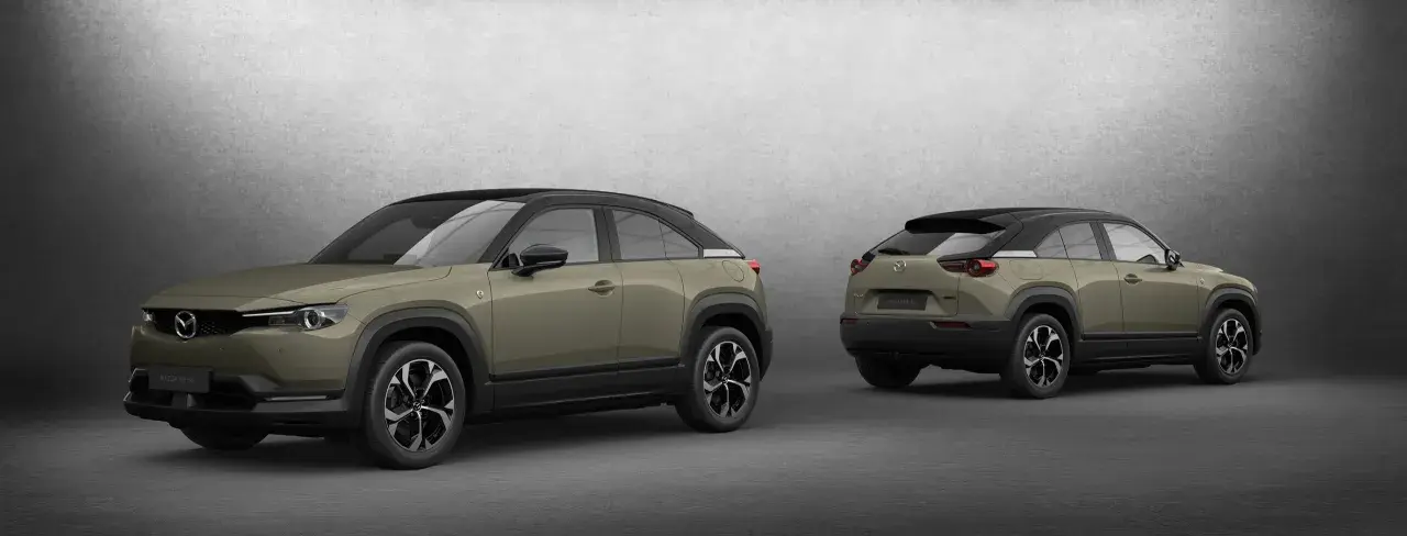 Dwa samochody Mazda MX-30 w kolorze oliwkowym z czarnym dachem, prezentowane z przodu i z tyłu.